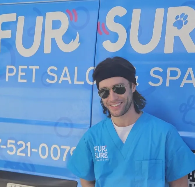 A dog groomer at Fur Sure grooming providing canine grooming services